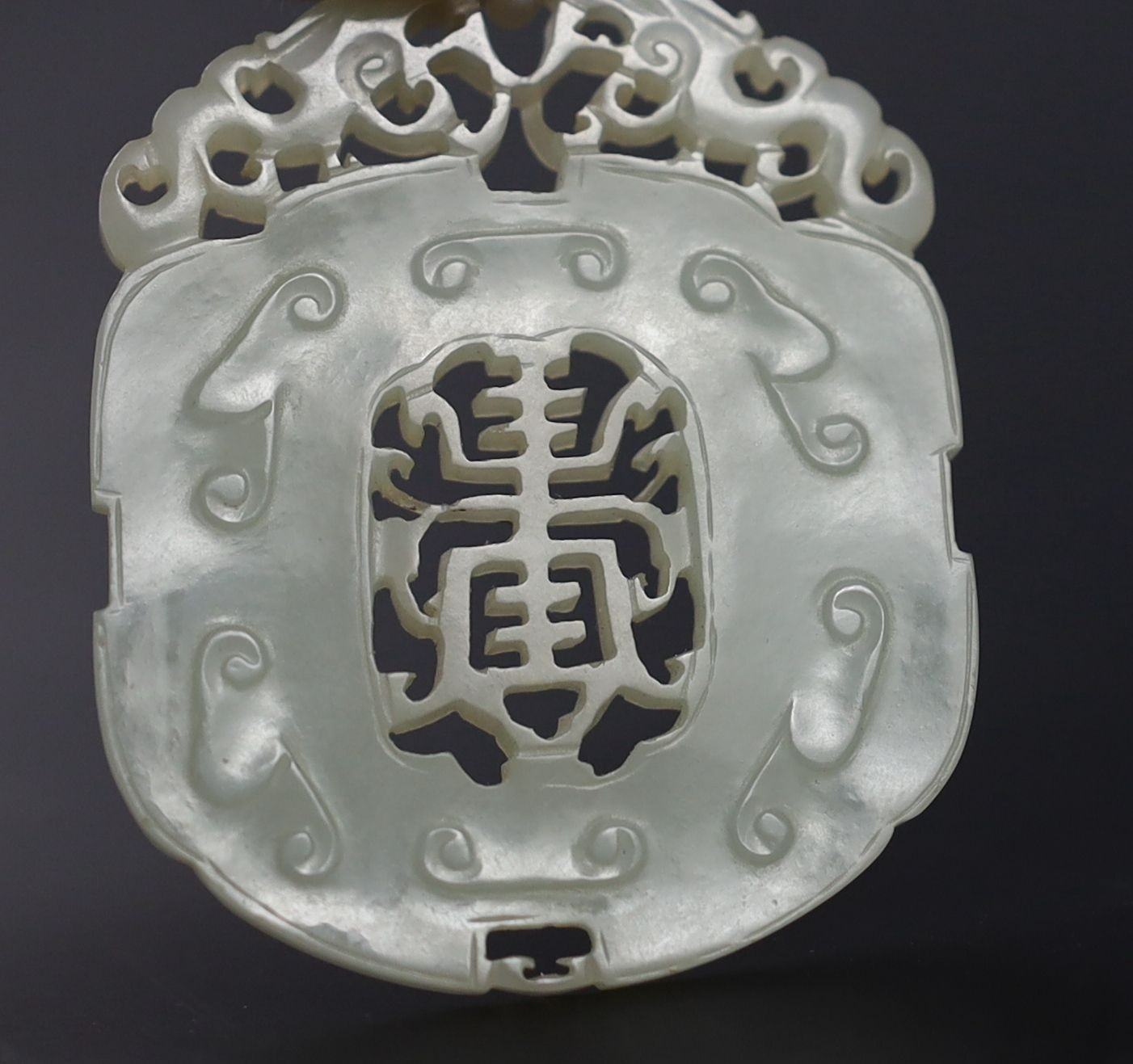 Two Chinese pale celadon jade openwork plaques, 19th century, 5.4 cm and 6.4 cm